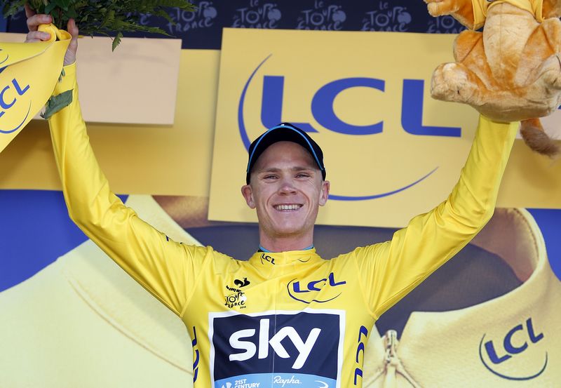 © Reuters. Team Sky rider Froome of Britain celebrates as he wears the race leader's yellow jersey on the podium of the third stage of the 102nd Tour de France cycling race