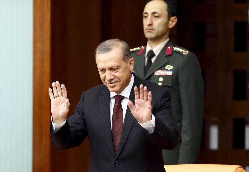 © Reuters. Turkey's President Tayyip Erdogan greets parliamentarians as he arrives at the Turkish parliament to watch a swearing-in ceremony in Ankara