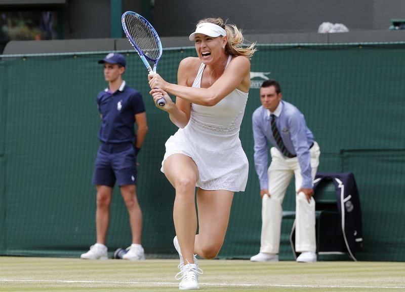 © Reuters. Maria Sharapova of Russia hits a shot during her match against Zarina Diyas of Kazakhstan at the Wimbledon Tennis Championships in London
