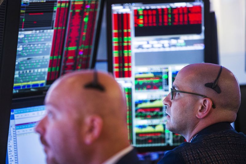 © Reuters. Traders work on the floor of the New York Stock Exchange shortly after the opening bell in New York