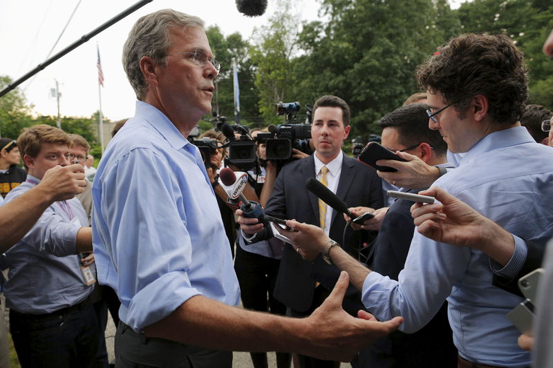 © Reuters. Bush answers a questions from reporters following a town hall campaign stop at the VFW Post in Hudson