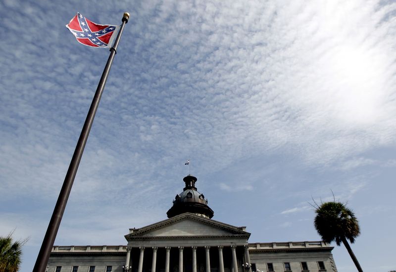 © Reuters. A Confederate flag stands in front of the South Carolina State House in Columbia