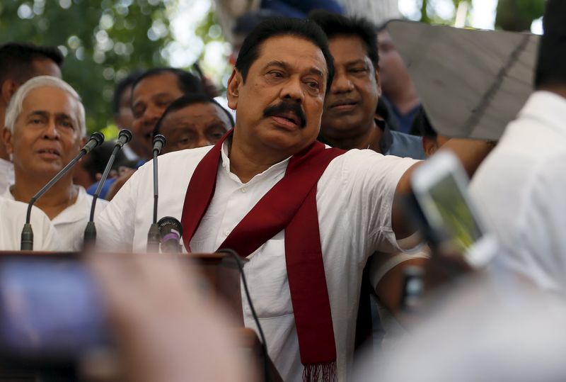 © Reuters. Former Sri Lankan president Rajapaksa speaks to his supporters at his residence in Medamulana