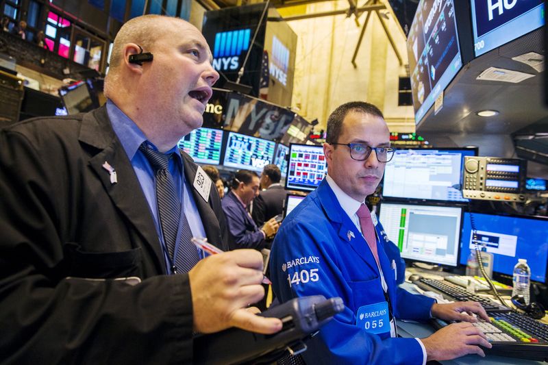 © Reuters. Traders work shortly after the opening bell on the floor of the New York Stock Exchange