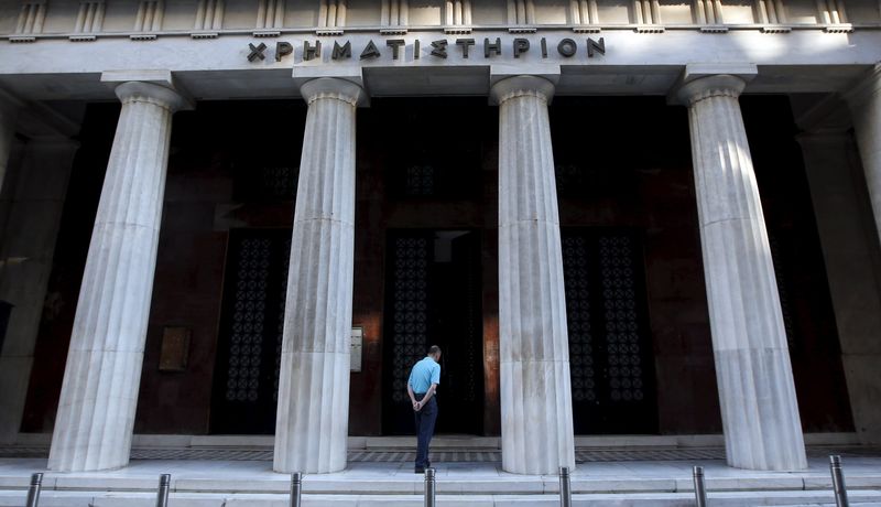 © Reuters. A man enters the old Stock Exchange building in central Athens