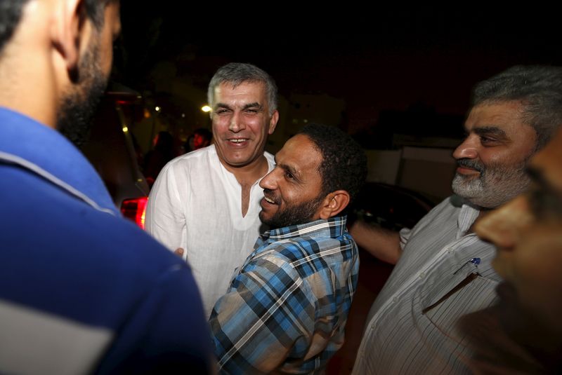 © Reuters. Bahraini human rights activist Nabeel Rajab is greeted by friends upon his arrival to his home after being pardoned by Bahrain's King Hamad, in the village of Bani Jamra, west of Manama