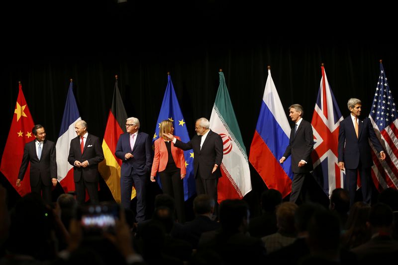 © Reuters. Ministers and officials arrive for a family picture after the last plenary session at the United Nations building in Vienna