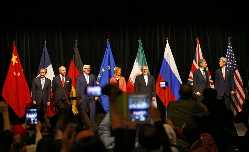 © Reuters. Ministers and officials pose for a family picture after the last plenary session at the United Nations building in Vienna