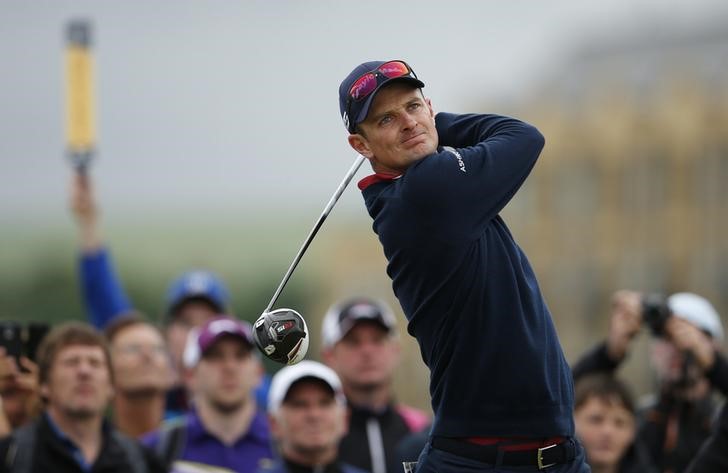 © Reuters. Rose of England watches his tee shot on the fourth hole during a practice round ahead of the British Open golf championship on the Old Course in St. Andrews, Scotland