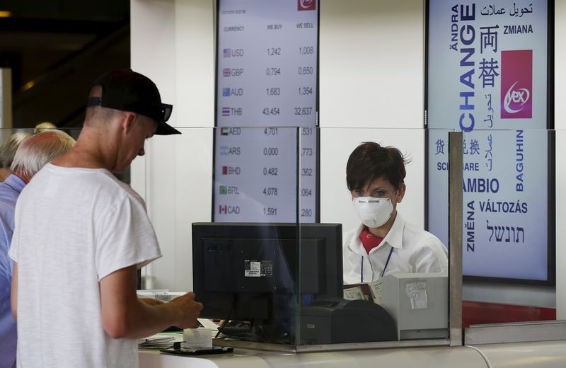 © Reuters. A woman wears a mask as she works at Fiumicino international airport in Rome