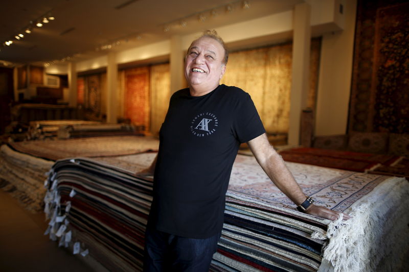 © Reuters. Alex Helmi, 59, owner of Damoka carpet store, which he has owned for 26 years, stands amongst his Persian carpets in Westwood, Los Angeles