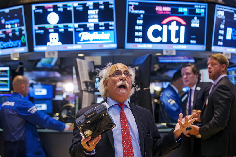 © Reuters. Trader Tuchman gestures as he talks on the phone following the resumption of trading following a several hour long stoppage on the floor of the New York Stock Exchange