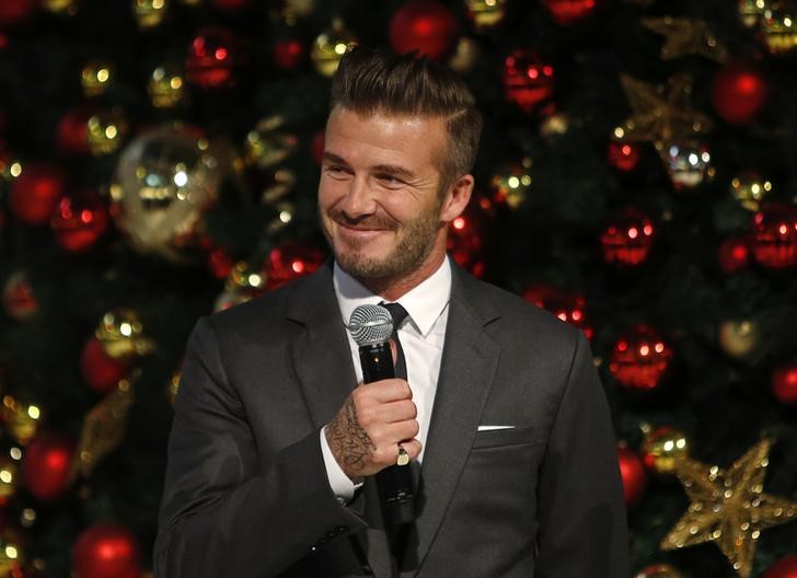 © Reuters. David Beckham speaks before launching Christmas lights at the Marina Bay Sands shopping mall in Singapore