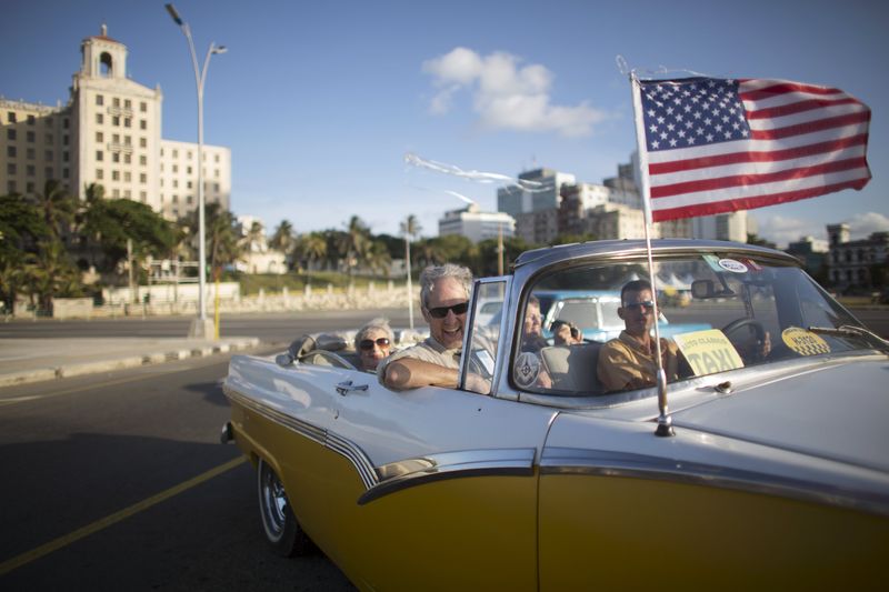 © Reuters. Veit enjoys a ride in a vintage car at the seafront Malecon during a cultural exchange trip in Havana