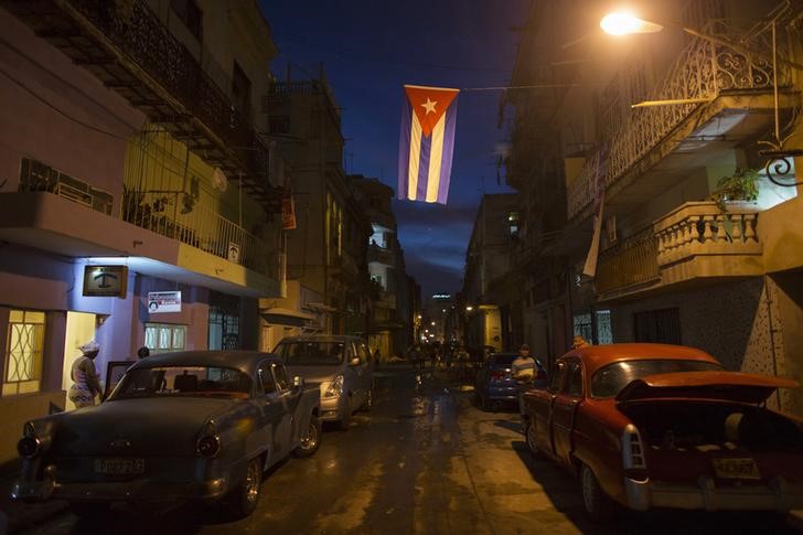 © Reuters. A Cuban national flag hangs over the street in downtown Havana