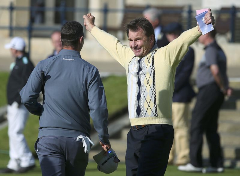 © Reuters. Faldo of England (R) gestures towards compatriot Justin Rose after completing his round on the 18th hole during the second round of the British Open golf championship on the Old Course in St. Andrews, Scotland