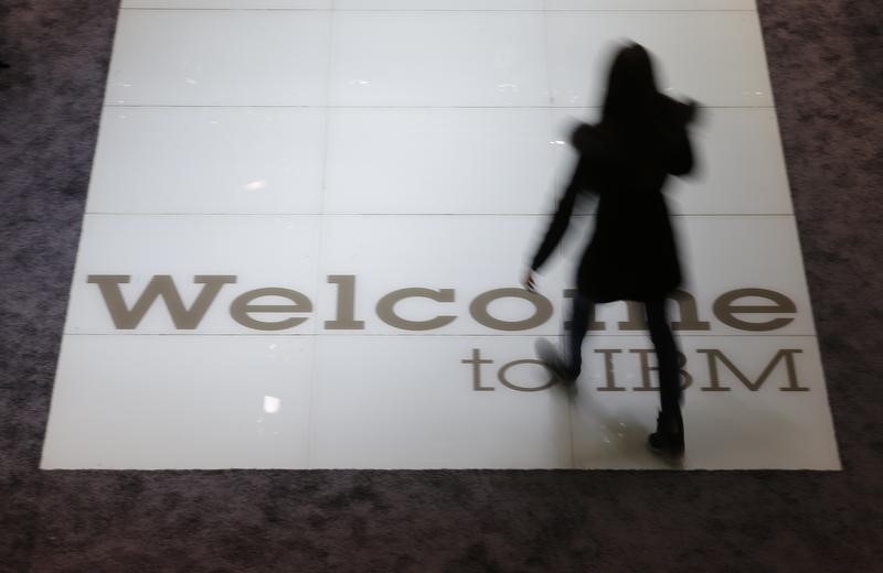 © Reuters. A woman walks over a welcoming sign at the booth of IBM at the CeBIT trade fair in Hanover