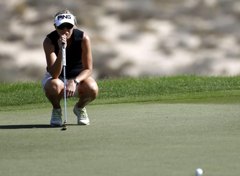 © Reuters. Koch of Sweden lines up her shot on the 8th hole during the first round of the Dubai Ladies Masters