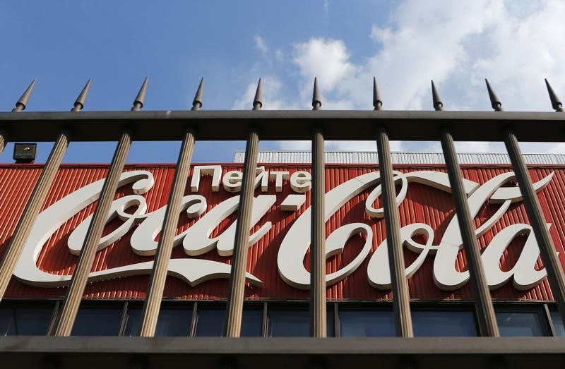 © Reuters. A logo of Coca-Cola is seen through a fence outside a plant of the company on the outskirts of Moscow