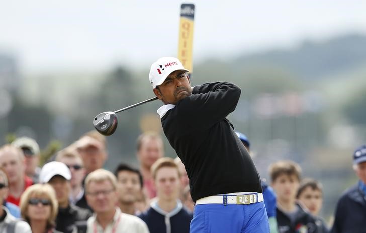 © Reuters. Lahiri of India watches his tee shot on the fourth hole during the final round of the British Open golf championship on the Old Course in St. Andrews, Scotland