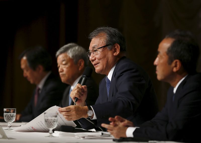 © Reuters. Nikkei's Chairman Kita speaks during news conference as Chief Manager Arakawa, President and CEO Okada and Senior Managing Director Nomura listen in Tokyo