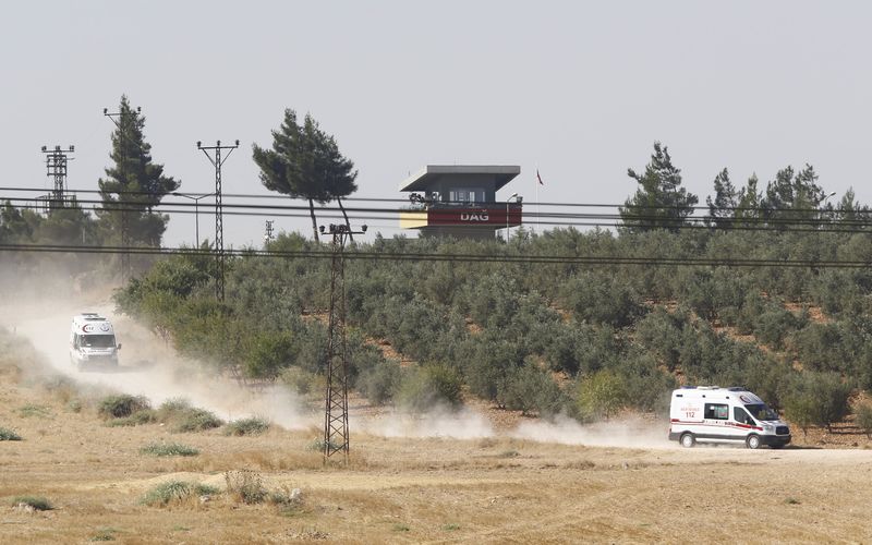 © Reuters. Ambulances leave from the Dag military post, which was attacked by Islamic State militants on Thursday, on the Turkish-Syrian border near Kilis, Turkey,