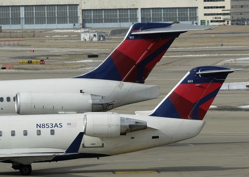 © Reuters. Two delta Airlines jets  sit at their gates at the Lambert - St. Louis International Airport