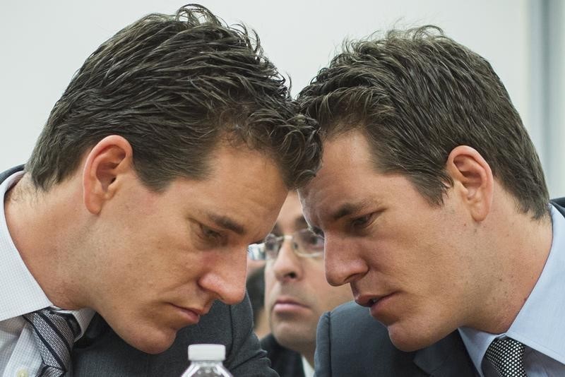 © Reuters. Brothers Cameron and Tyler Winklevoss talk to each other as they attend New York State Department of Financial Services virtual currency hearing in Manhattan borough of New York