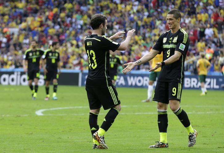 © Reuters. Spain's Juan Mata celebrates with Fernando Torres after scoring a goal during the 2014 World Cup Group B soccer match between Australia and Spain at the Baixada arena 