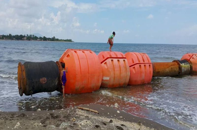 © Reuters. A boy standing on buoys at the shoreline of Iba, Zambales, in northern Philippines is seen in this undated photo released by the Philippine Coastguard