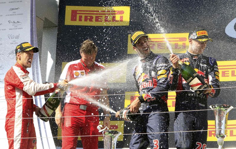 © Reuters. Winner Ferrari Formula One driver Vettel of Germany splashes with champagne on the podium after the Hungarian F1 Grand Prix at the Hungaroring circuit, near Budapest