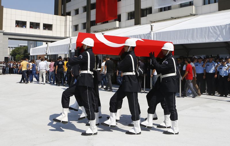 © Reuters. Coffin of police officer Muhammet Fatih Sivri is carried by his fellow officers during his funeral ceremony in Istanbul