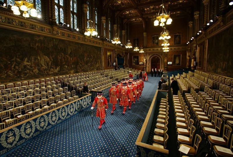 © Reuters. Yeoman of the Guard, wearing traditional uniform, walk through the Royal Gallery during the ceremonial search before the State Opening of Parliament in the House of Lords at the Palace of Westminster, in central London
