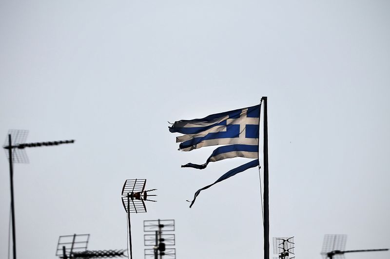 © Reuters. A frayed Greek national flag flutters among antennas atop a building in central Athens