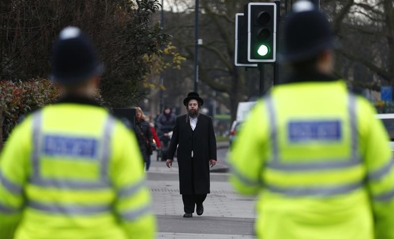 © Reuters. A member of the Jewish community walks in north London