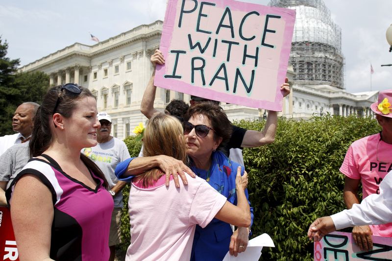 © Reuters. Rep. Jan Schakowsky hugs Code Pink activist at an event of activists delivering more than 400,000 petition signatures to Capitol Hill 