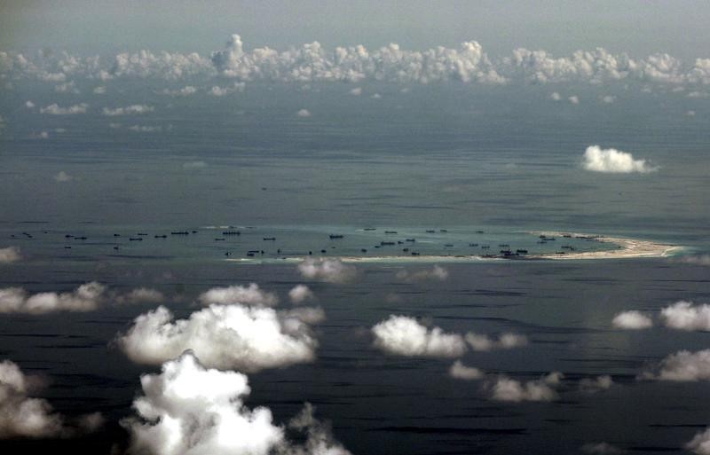 © Reuters. An aerial photo taken though a glass window of a Philippine military plane shows the alleged on-going land reclamation by China on mischief reef in the Spratly Islands