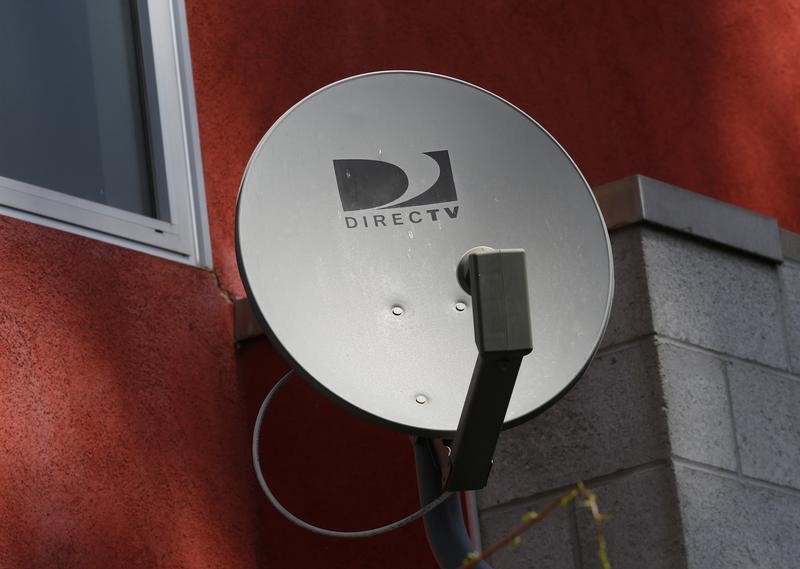 © Reuters. A DirecTV satellite dishe is seen on an apartment wall in Los Angeles