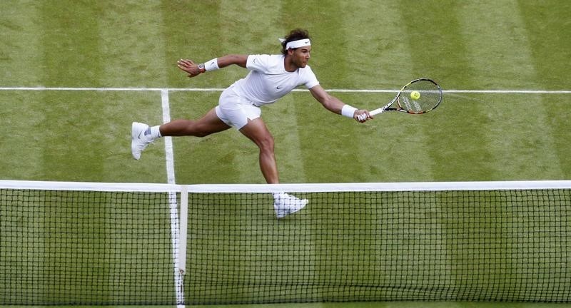 © Reuters. Rafael Nadal of Spain hits a shot during his match against Dustin Brown of Germany at the Wimbledon Tennis Championships in London