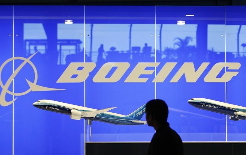 © Reuters. A man looks at a scale model of Boeing's 787 dreamliner at their booth at the Singapore Air Show in Singapore