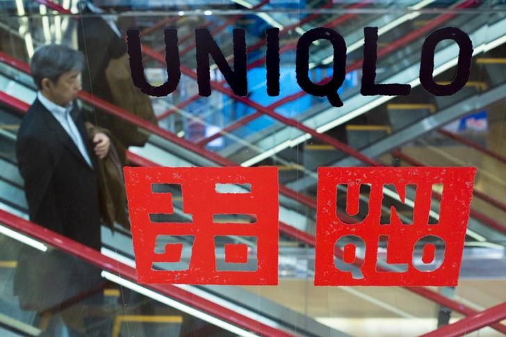 © Reuters. Man rides escalator at Uniqlo flagship store in Tokyo