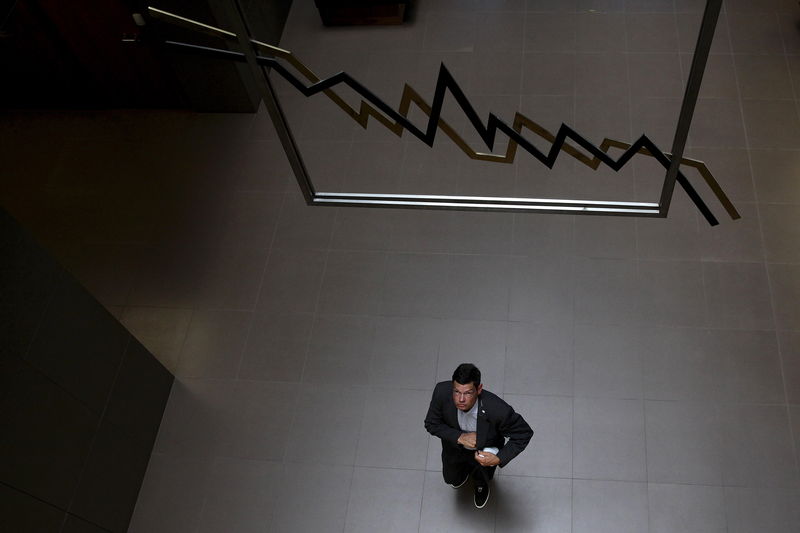 © Reuters. A man walks inside the Athens Stock Exchange in Greece 