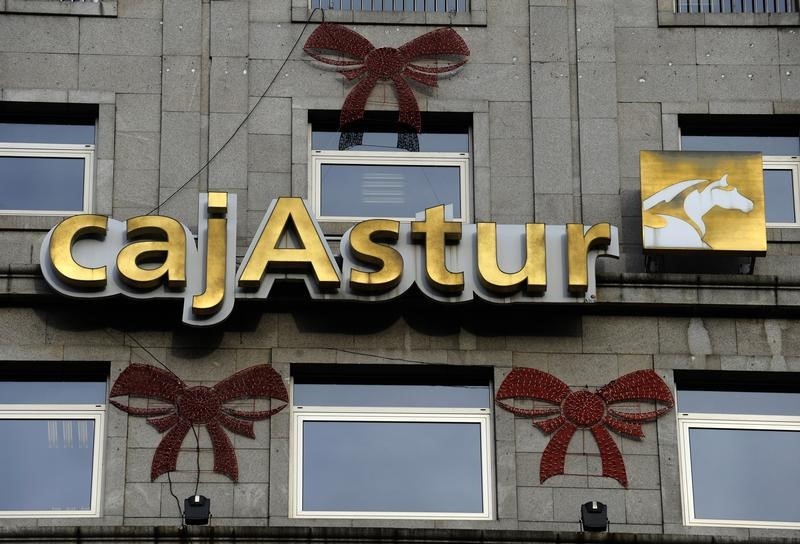 © Reuters. The logo of Cajastur, which is part of Liberbank, is surrounded by Christmas decoration in Oviedo
