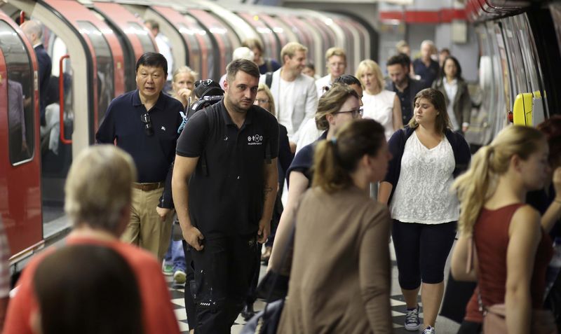 © Reuters. People disembark from a tube train at an underground station in London