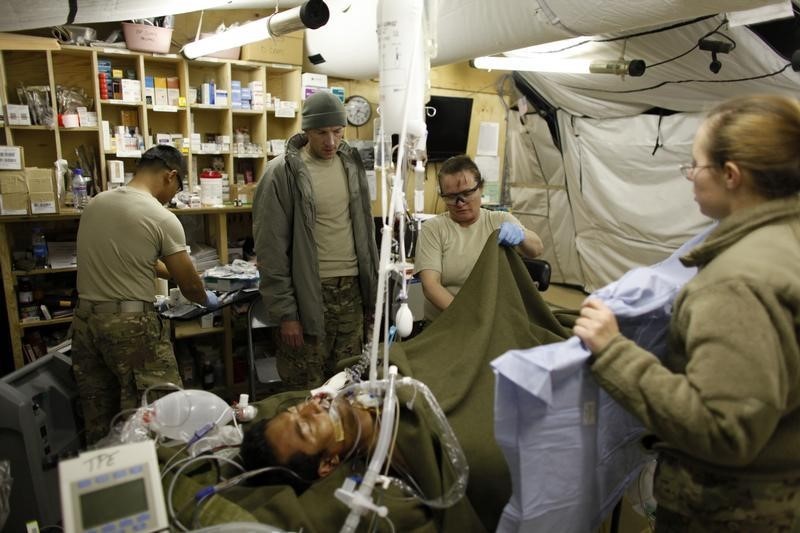 © Reuters. U.S. MAJ. David R. King MD, Chief of Surgical Services of 125 BSB Forward Surgical Team Task Force Mustang, controls his patience after he operated on him in Forward Operating Base Shank in Logar province