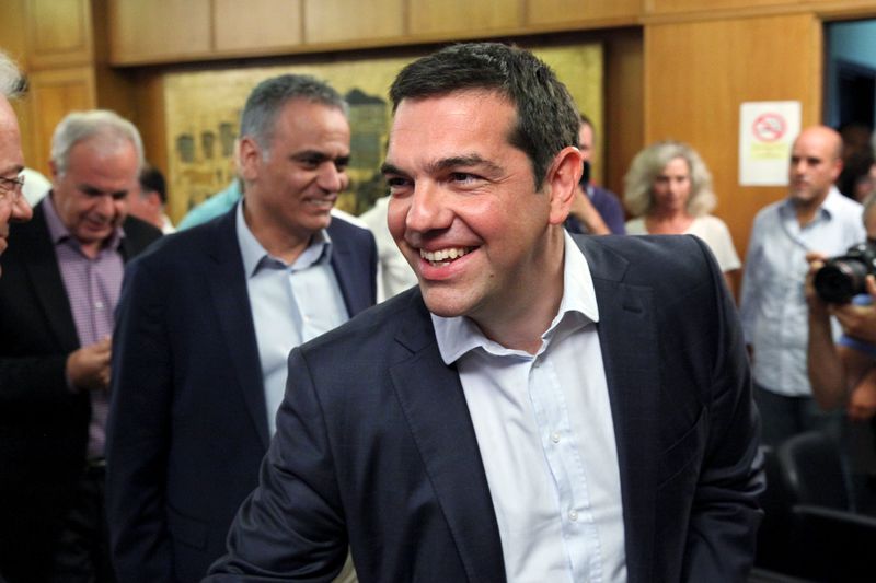 © Reuters. Greek Prime Minister Tsipras smiles as he greets people at the Agriculture Ministry in central Athens