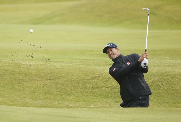 © Reuters. Scott of Australia hits out of a bunker on the 14th hole during the final round of the British Open golf championship on the Old Course in St. Andrews, Scotland