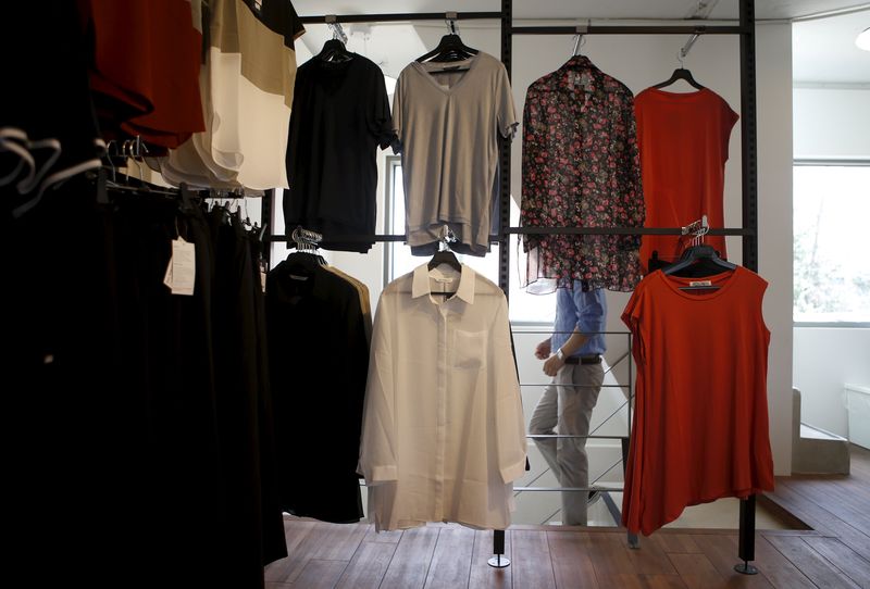 © Reuters. An employee walks past ladies' clothes at a store selling goods from the inter-Korean Kaesong Industrial Complex in North Korea, in Seoul