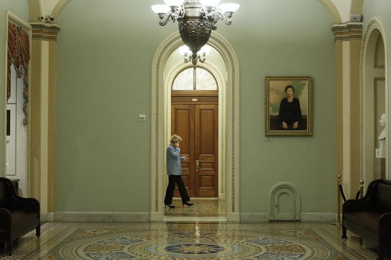 © Reuters. U.S. Senator Tammy Baldwin takes a call in the hallway during a long series of votes at the U.S. Capitol in Washington