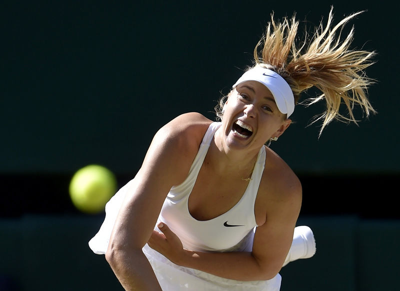 © Reuters. Maria Sharapova of Russia serves during her match against Serena Williams of the U.S.A. at the Wimbledon Tennis Championships in London